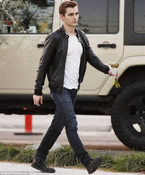 Dave Franco Grips On To A Small Bouquet Of Flowers As He Embraces A