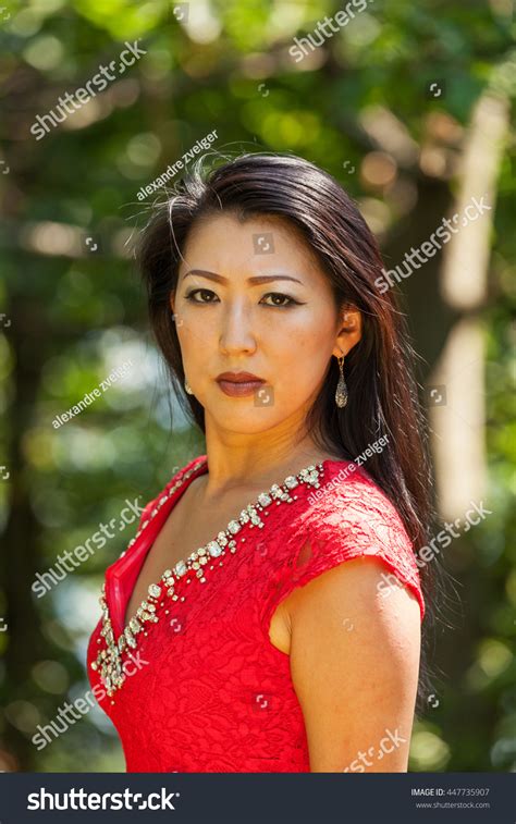 Стоковая фотография 447735907 Sexy Mature Asian Woman Red Dress