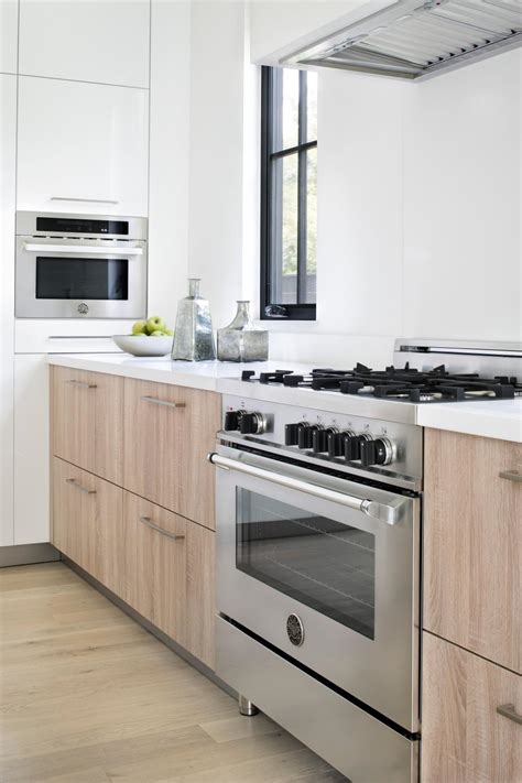 modern white farmhouse kitchen  stainless steel appliances  contemporary cabinets hgtv