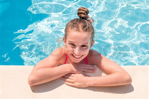 Teen Girl In Swimming Pool Squinting Her Eyes Stock Image Colourbox