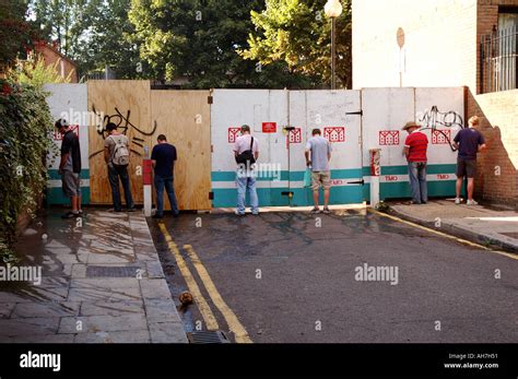 Men Urinating Against Hoardings In West London At Notting Hill Carnival