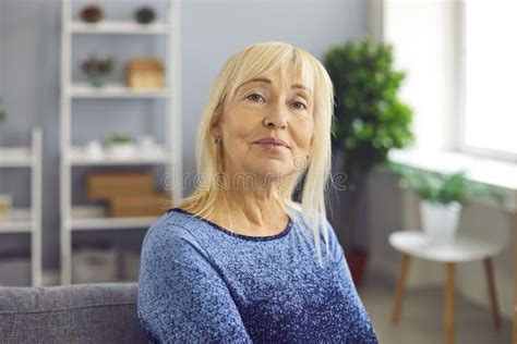 Portrait Of A Mature Woman Who Is Smiling Looking At The Camera While