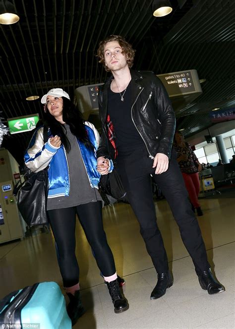 5sos star luke hemmings holds hands with raven haired stunner at brisbane airport daily mail