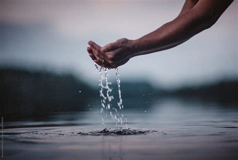 holding water  hands  calm lake nature landscape water droplets
