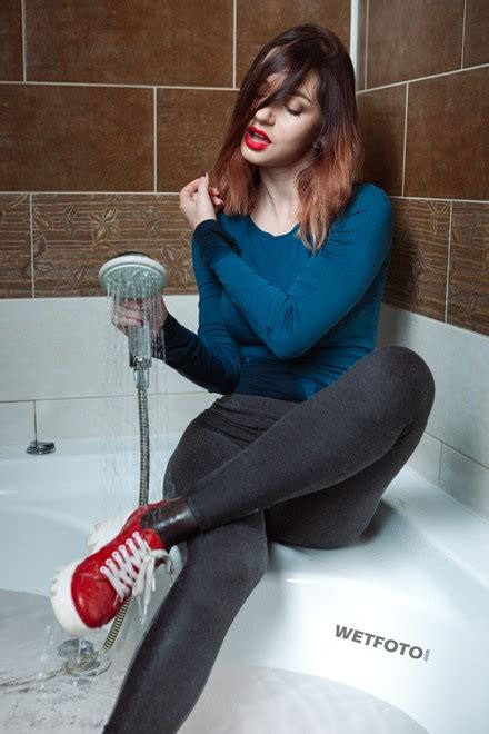 wetlook by sexy girl in blue sweater gray leggings and red shoes in