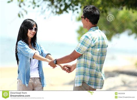 Happy Couple By The Beach Together In Holding Hands