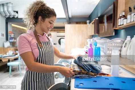 laundromat folding clothes photos and premium high res pictures getty