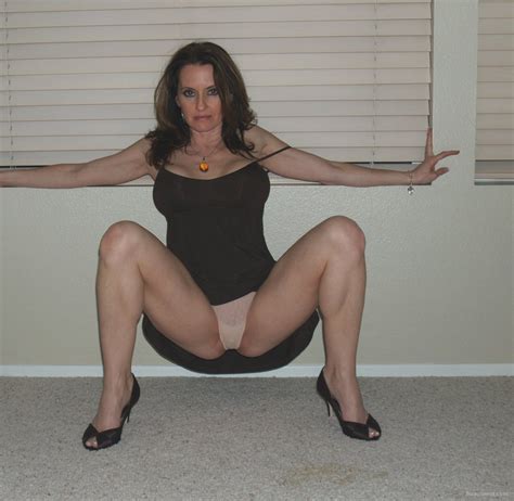 a very sexy bi milf posing at home lifting up her black dress to pleas