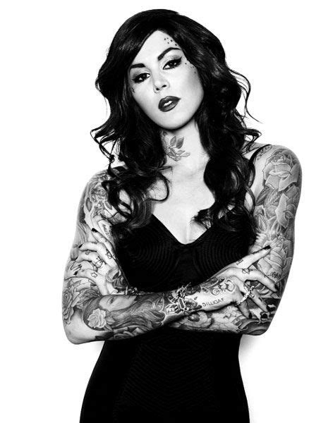 a woman with tattoos on her arms and chest posing for the cover of ink