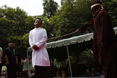 indonesian woman sobs as she is caned in public for having