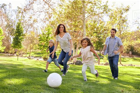 family playing soccer  park  stock photo dissolve