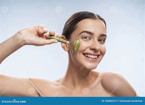 Cheerful Female Giving Herself A Facial Massage Stock Image Image Of