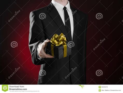 theme holidays and ts a man in a black suit holds