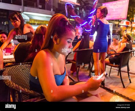nightlife barmaid holding smartphone clubs phnom penh cambodia