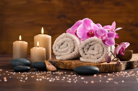 premium photo spa setting  brown rolled towel  orchids