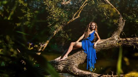 women outdoors branch trees blue dress barefoot blonde
