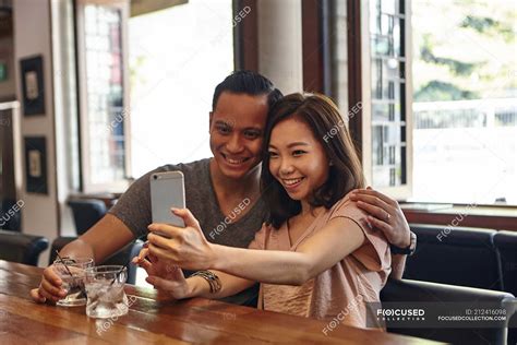 Young Asian Couple Making Selfie At Restaurant — Facial Expression