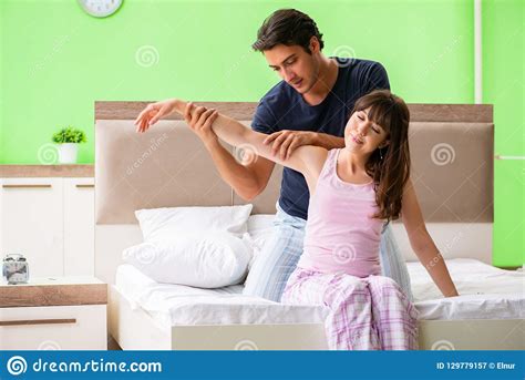 The Man Doing Massage To His Wife In Bedroom Stock Image