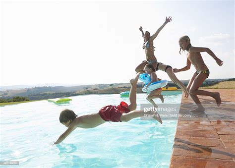 Five People Jumping Into Swimming Pool Photo Getty Images