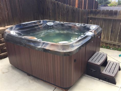 jacuzzi brand   person hot tub spa massage  luxury hot tub insider