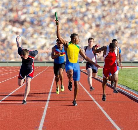 athletes running relay race stock photo dissolve