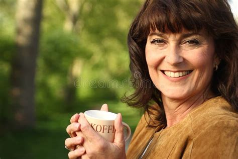 Beautiful Happy Mature Caucasian Woman Outside In The Park Stock Image