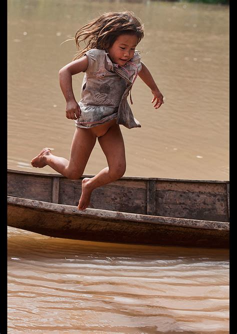 Lanten Girl Jumping Out Of Her Dugout Canoe On The Nam Ha