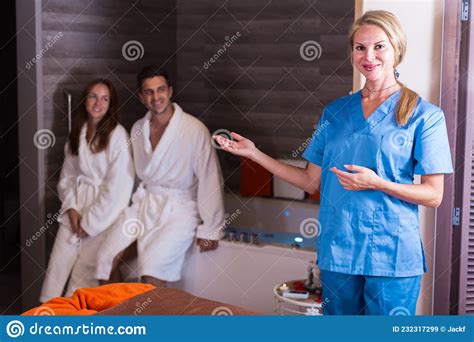 Woman Massagist Is Ready For Meet Couple In Massage Cabinet Stock Image
