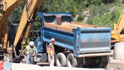 blue kenworth dump truck dumping dirt   road construction site youtube
