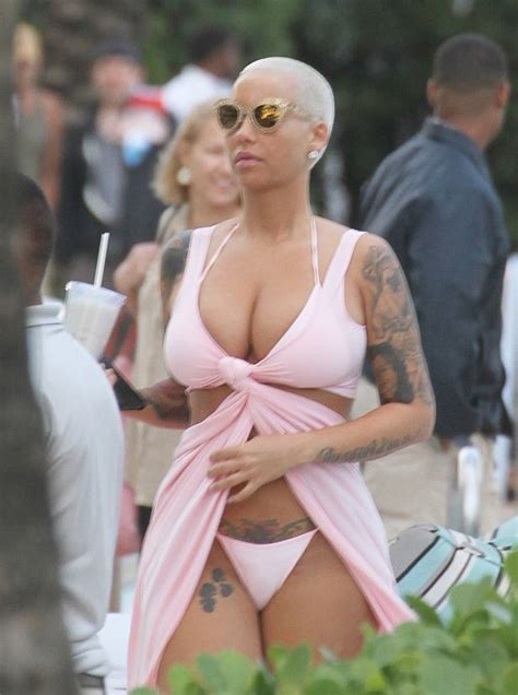 Amber Rose Squeezes Her Cleavage Into Flesh Flashing Beach Wrap And