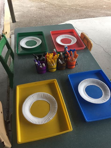 colored plates   table  pens  pencils   trays