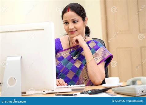 happy traditional indian business woman at office desk stock image