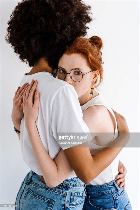 Multicultural Lesbian Couple Women Hugging Indoors On White Background