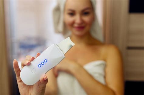 premium photo ultrasonic scrubber for facial skin cleansing girl in
