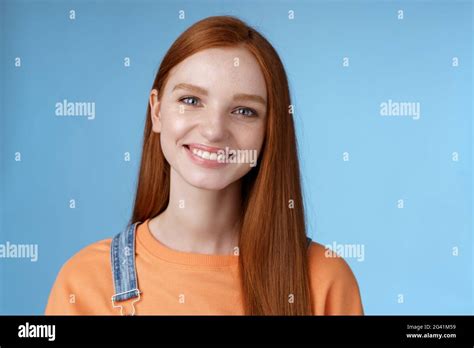 cheerful lively redhead caucasian girl smiling happily  camera kind