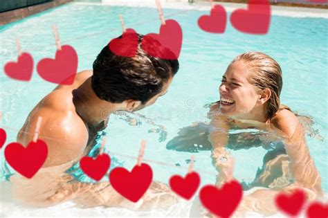 cute couple having fun in the swimming pool stock image