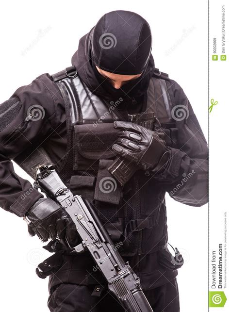 swat officer with assault rifle in black uniform isolated