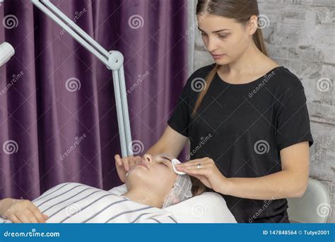 relaxed young woman  facial massage  spa salon stock photo