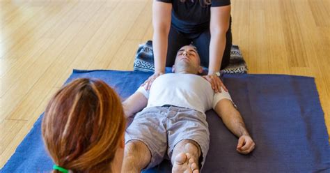 thai massage throughout restorative yoga class
