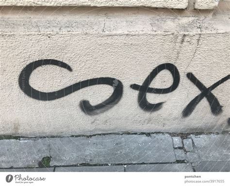 sex is written as graffiti on a house facade a royalty free stock
