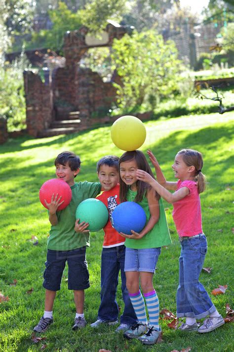 children playing  balls  grass stock photo dissolve