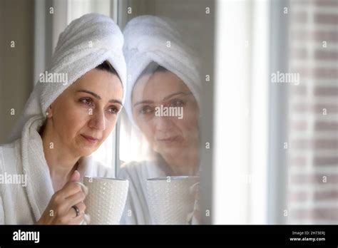 Moody Photo Of A Middle Aged Woman With Towel Turban On Her Head During