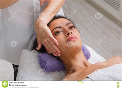 woman massagist make face lifting massage in spa wellness