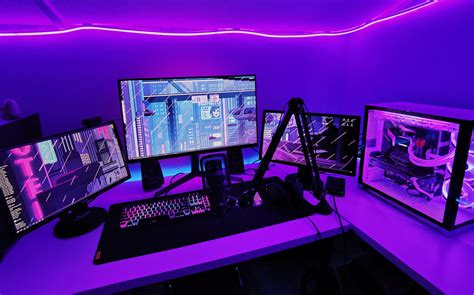 computer monitors sitting  top   desk      front   purple light