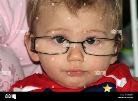 young boy wearing adult spectacles stock photo alamy