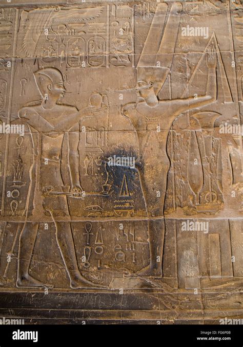 relief of the god min ejaculating into a container carved upon the