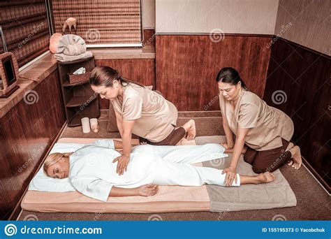 Woman Getting Back Massage By Two Masseuses Stock Image Image Of