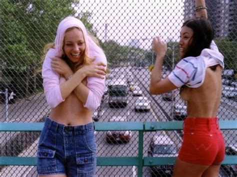 two cute embarrassed girls flashing their boobs on a bridge porn pic