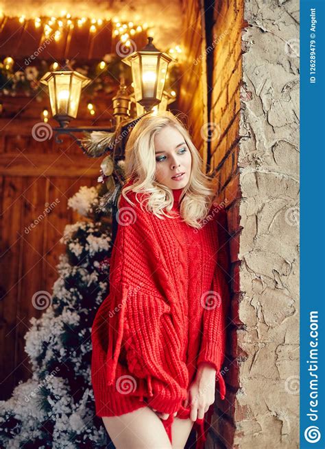 christmas fashion woman blonde in the red sweater having fun and