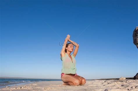 woman in bikini kneeling on the beach picture and hd photos free